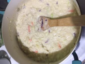 pot full of colcannon soup with a spoon