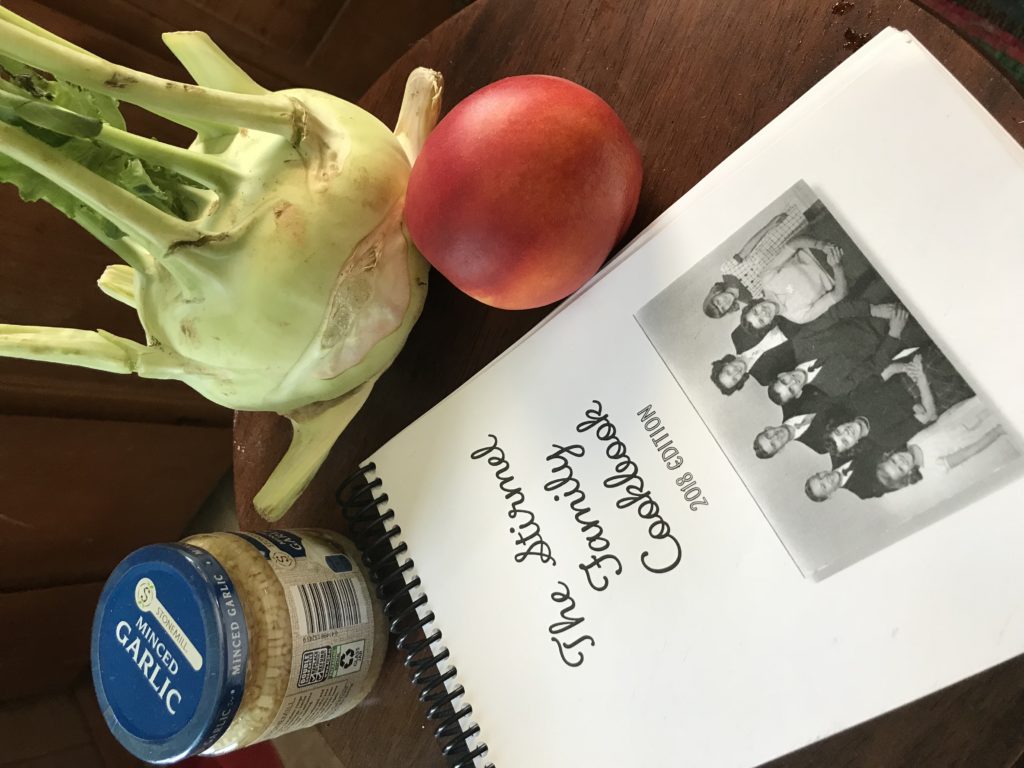 stirmel family cookbook with garlic, kohlrabi, and a nectarine