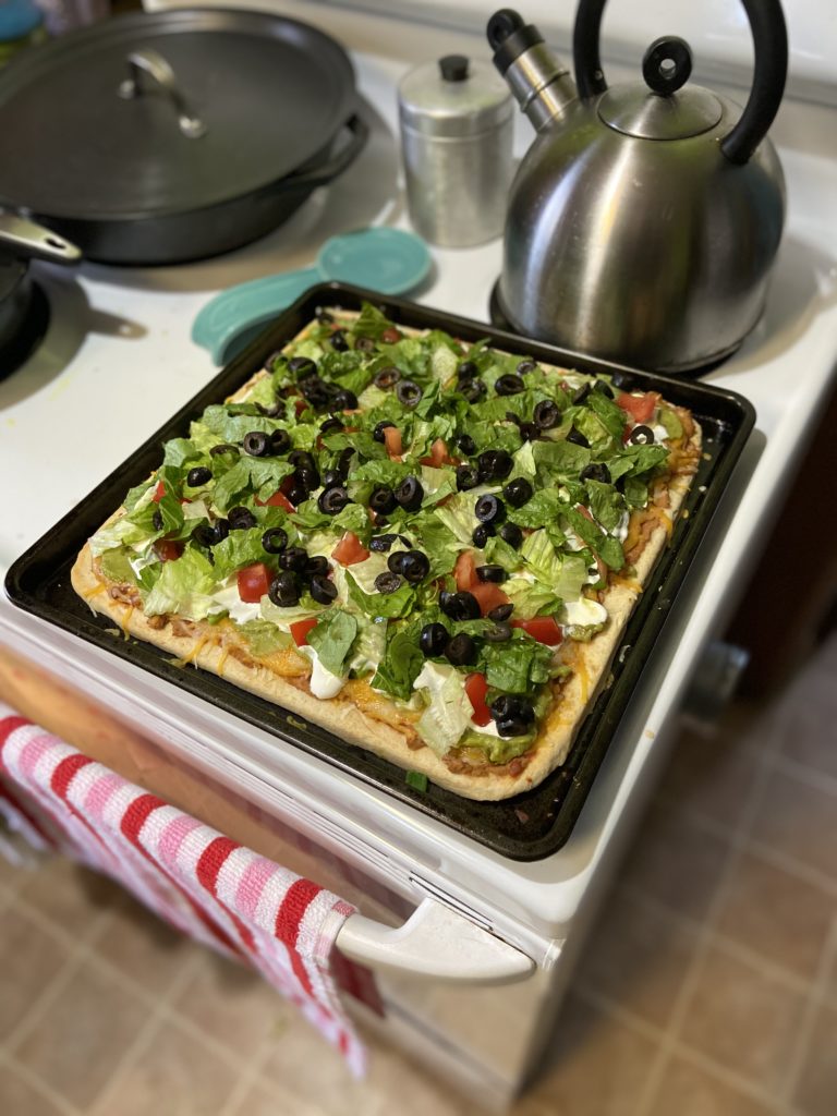 tostada pizza in square pan on top of stove